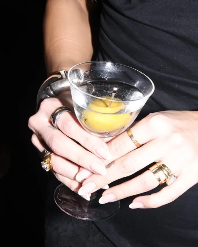 A martini with olives held at a Dion event