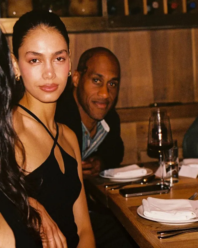 Members at a long dinner table in a wine bar